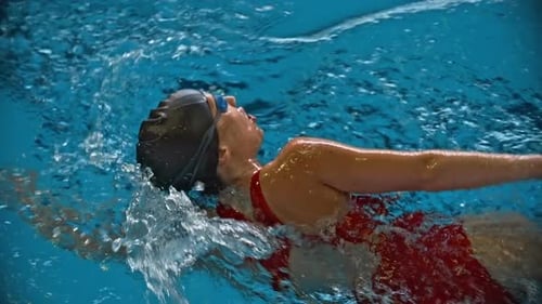 Female Swimmer Freestyle in Bright Blue Pool