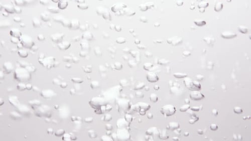 Bubbles forming from liquid mixing as it is poured