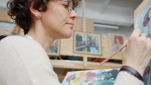 Close-up of Young Lady Painter Creating Beautiful Picture Painting Watercolor Portrait