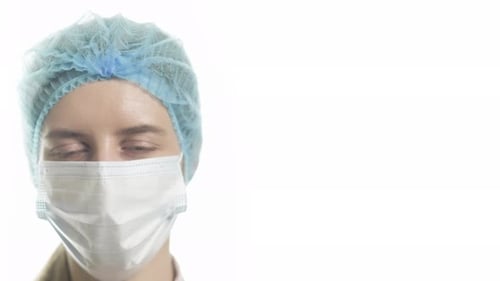 Portrait of a Female Doctor in Medical Uniform is Looking at Camera at Hospital Close Up