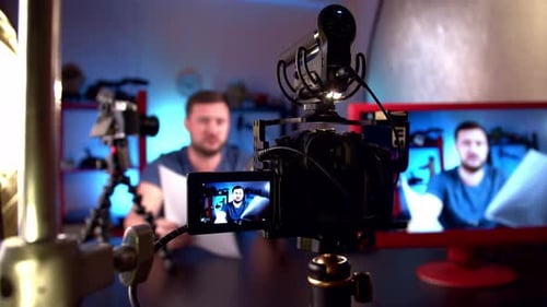 Blogger is Broadcasting in Video Studio with Cameras and Professional Lighting