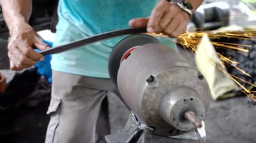 Sharpening Machete Blade on Grinding Machine with Sparks