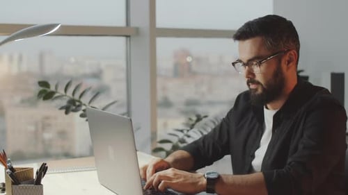 Young Professional Businessman Using Laptop in Office