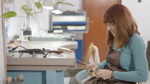 Woman Crafting Jewelry with Hammer in Studio