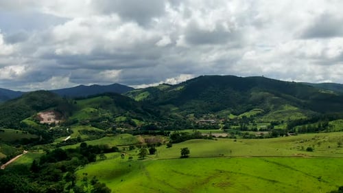 Aerial View of Green Tropical Mountain and Small Valley During Clouded Day