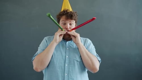 Adult Man Celebrates with Party Horns and Hat