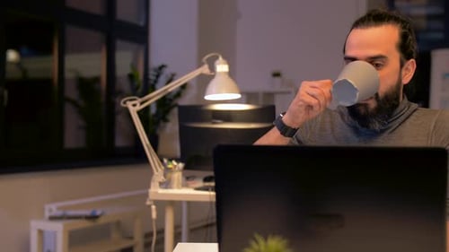 Man Working Late at Night on Computer