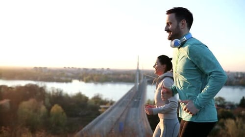 Athletic Couple Jogging at Sunrise