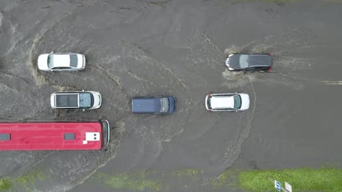 Aerial View of City Traffic with Cars Driving on Flooded Street After Heavy Rain