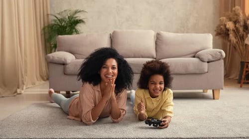 Playful Adult and Child Enjoying Video Games Together