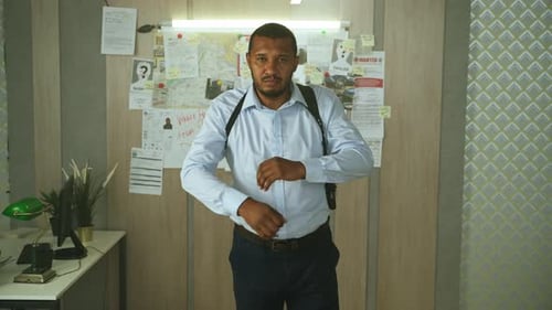 Confident Detective Stands with Arms Crossed in Office