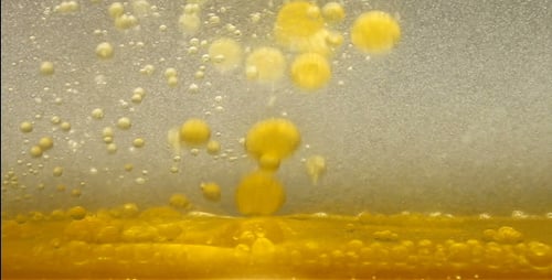 Yellow Viscous Liquid and Bubbles, Abstract Close Up