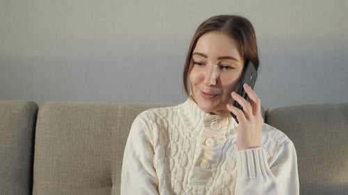 Woman Talking on Mobile Phone Indoors