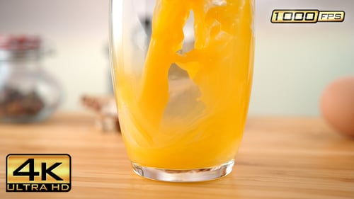 Pouring Fresh Orange Juice in a Glass
