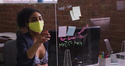 Woman in Mask with Note in Modern Office