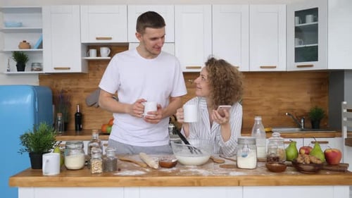 Cheerful Couple Cooking Together in a Bright Kitchen