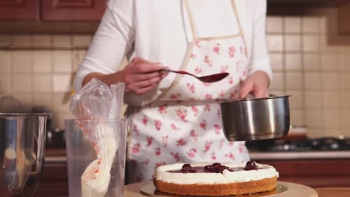 Woman Decorating a Cake in Kitchen at Home