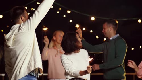 Friends with Sparklers Dancing at Rooftop Party 62