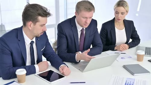 Adults in Corporate Business Meeting Looking at Laptop
