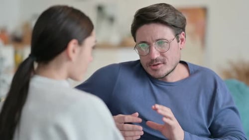 Man Talking to Woman Indoors