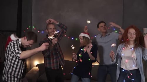 Friends Celebrate Christmas Dancing with Sparklers at Home