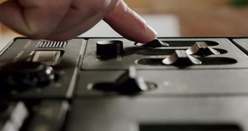 Male Fingers Adjust the Switches on the Device