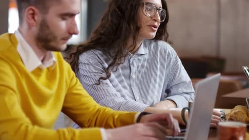 Woman Chatting with Colleague at Coffee Break in Cafe