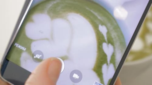 Photographing matcha latte with latte art design