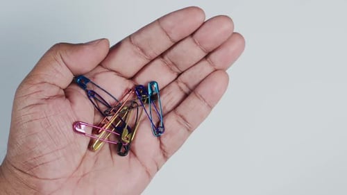Hand Holding Safety Pins