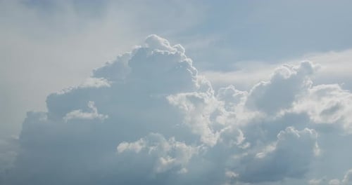 Puffy White Clouds Floating Across a Blue Sky