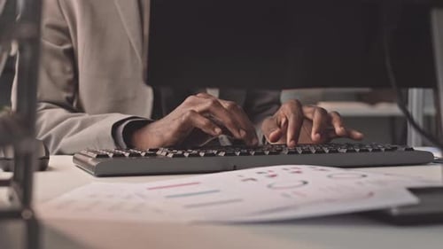Man Typing on Keyboard
