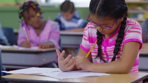 Students writing in school classroom