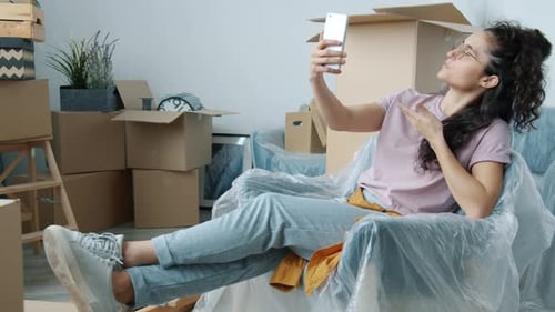 Woman Video Chatting in New Home with Boxes