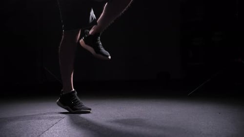 Legs Jumping Rope in Dark Gym