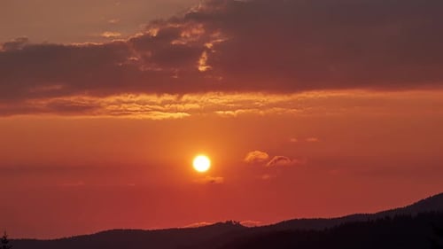 The Setting Sun Over The Horizon. Warm Orange Red Shades Of The Sky