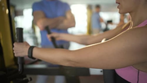 Personal Trainer Giving Advice to Woman During Workout in Gym, Healthy Lifestyle