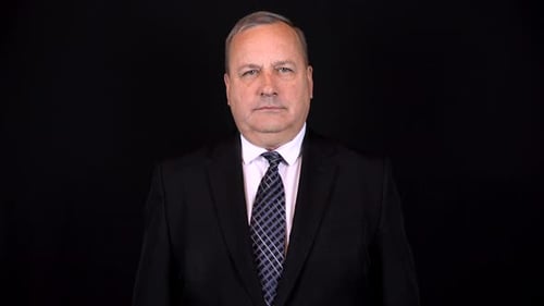 Man in Suit Smiling on Black Background