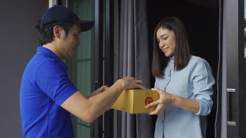 Friendly Delivery Man Giving Woman a Package