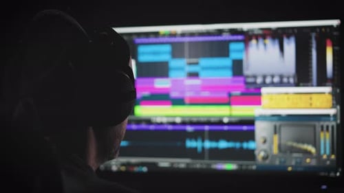 An Experienced Sound Engineer Mixes a Music Track in His Home Studio