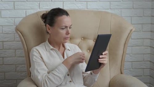 Woman with Cold Using Tablet at Home