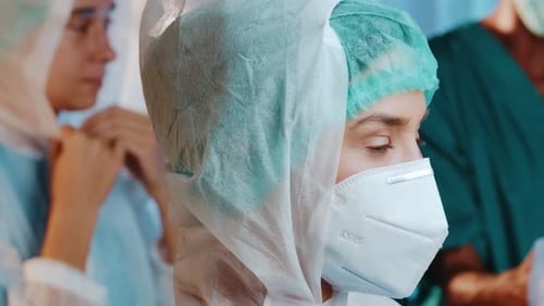 Medical Staff Prepares in Gowns and Face Masks
