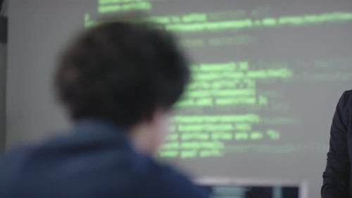 Tutor Giving IT Lesson To Young Programmers