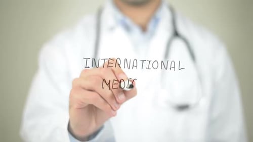 Doctor Writing International Medicine on Clear Screen