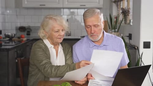 Senior Couple Looks over Home Finances Together