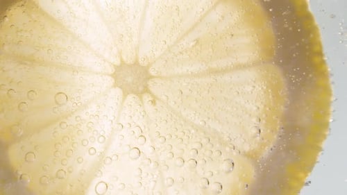 Translucent Lemon Slice Floating in Bubbly Water