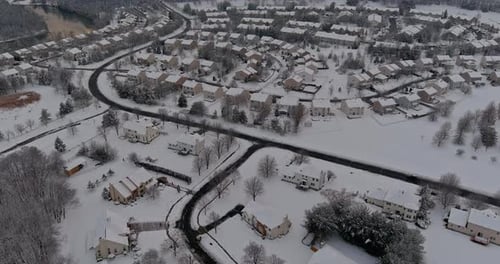 Snowfall Over Small Town Residential with Snow Covered Roofs Houses in USA Countryside