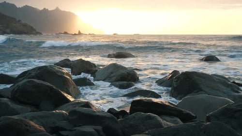Ocean Waves Crash on Rocks and Spray in Beautiful Sunset Light at Benijo Beach in Tenerife, Canary
