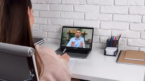 Woman Participating in Video Call at Desk