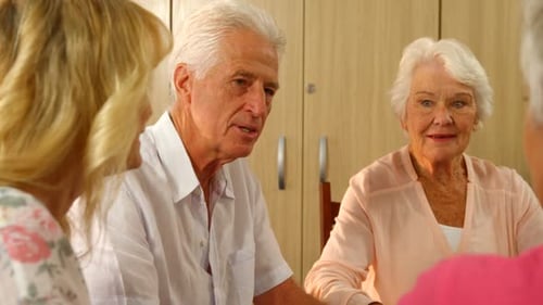 Senior Friends Enjoying Conversation and Laughing Together