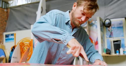 Man making surfboard